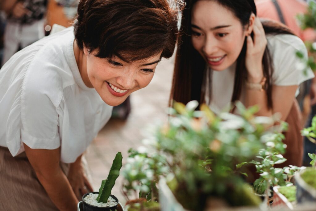 women-inspecting-plants Two women inspecting plants in a nursery
